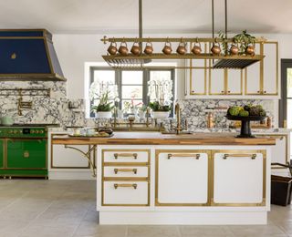 a officine gullo white kitchen with a green range and blue cooker hood