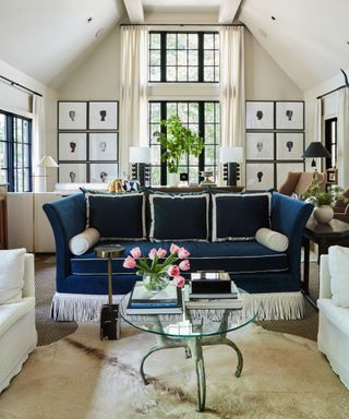 living room with cream walls and dark navy couch