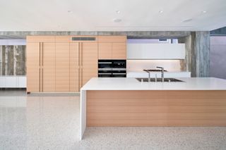 Venice Beach house by Dan Brunn, showing timber clad kitchen and white surfaces