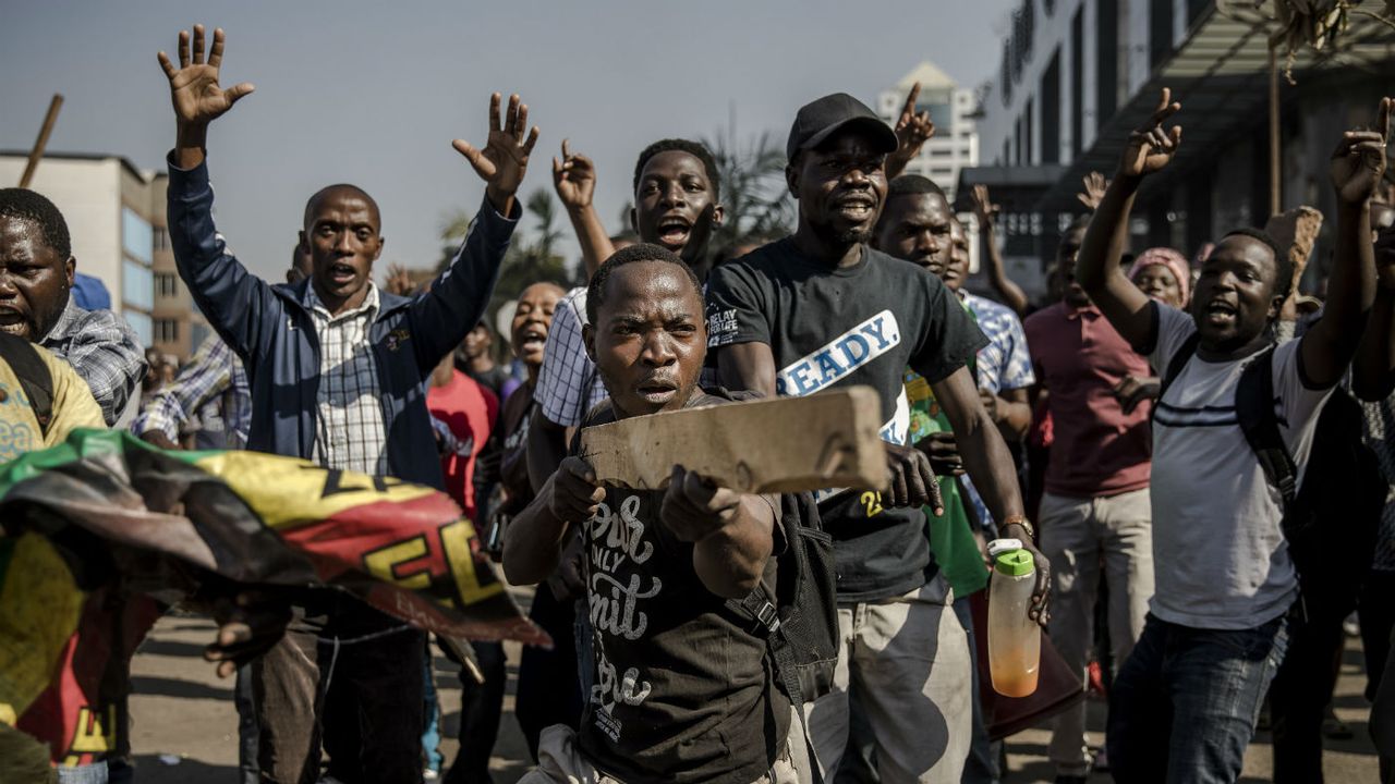 Supporters of MDC Alliance take part in a protest in Harare at alleged election rigging