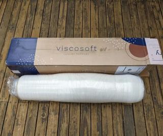 The Viscosoft Active Cooling Copper Topper in plastic wrap beside a ViscoSoft delivery box.