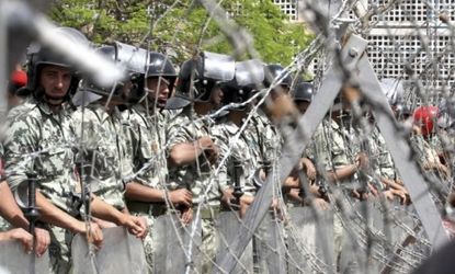 Egyptian military police stand guard near the Ministry of Defense in Cairo: Protesters last month organized a sit-in calling for a transitional government.