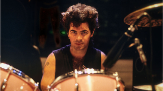 Portrait of American Rock musician Thommy Price as he sits behind his drum kit, Washington DC, 1981.