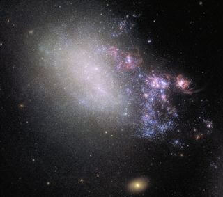What was once a spiral galaxy much like the Milky Way has been reduced to a shapeless swarm of stars and cosmic dust thanks to the gravitational pull of a galactic neighbor. In this Hubble image, NGC 4485 — which is now categorized as an "irregular" galaxy — is being distorted by the spiral galaxy NGC 4490, located out of the frame of this image to the bottom right.