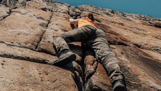 Low angle of a woman crack climbing