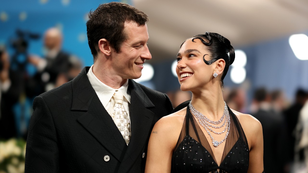 (L-R) Callum Turner and Dua Lipa attend the 2025 Met Gala Celebrating "Superfine: Tailoring Black Style" at Metropolitan Museum of Art on May 05, 2025 in New York City. They's looking at each other and smiling. 