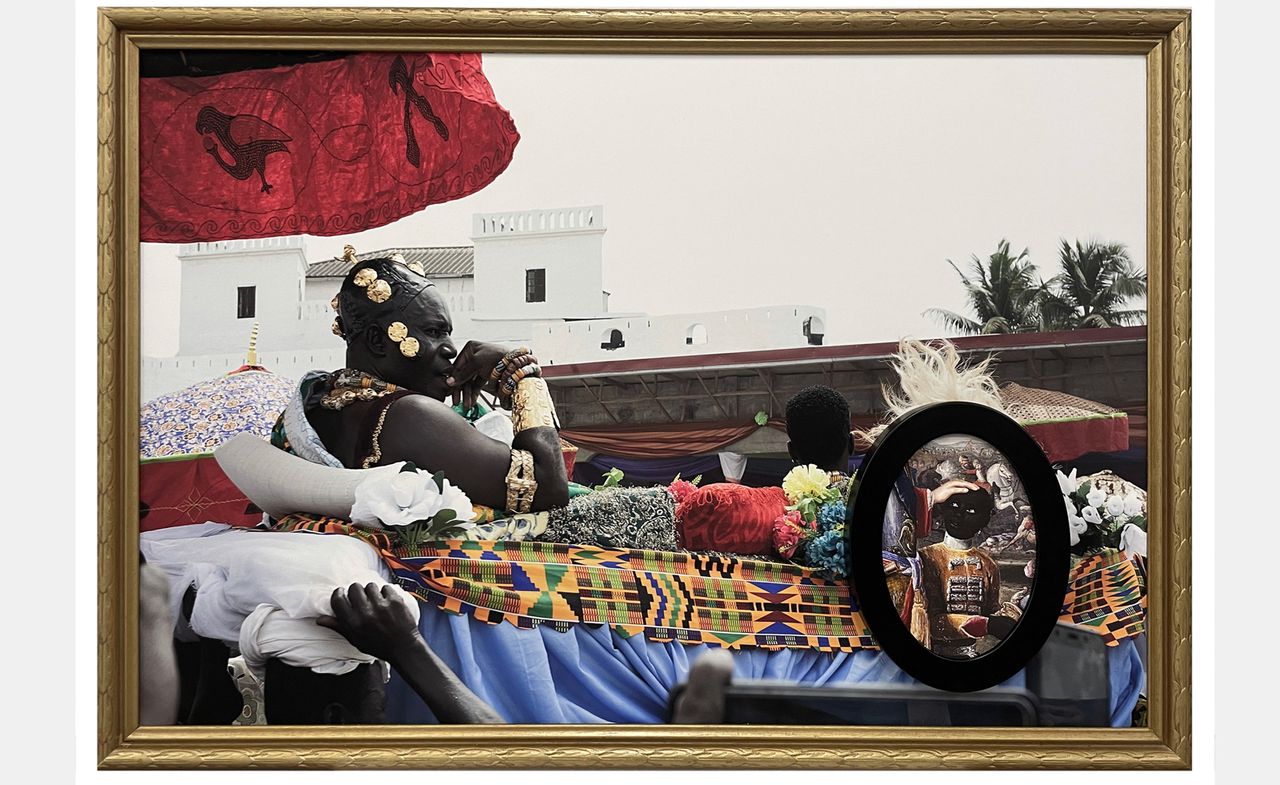 Todd Gray artwork. In a large rectangular gold frame, an African man with a concerned expression wearing gold jewelry reclines, being carried on a platform by other people. A small ovular black frame sits to the right, depicting an old painting of a Black boy with a white hand on his head, gazing up.