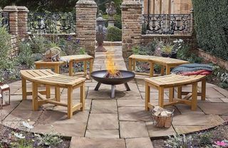 Four curved wooden benches around a fire pit