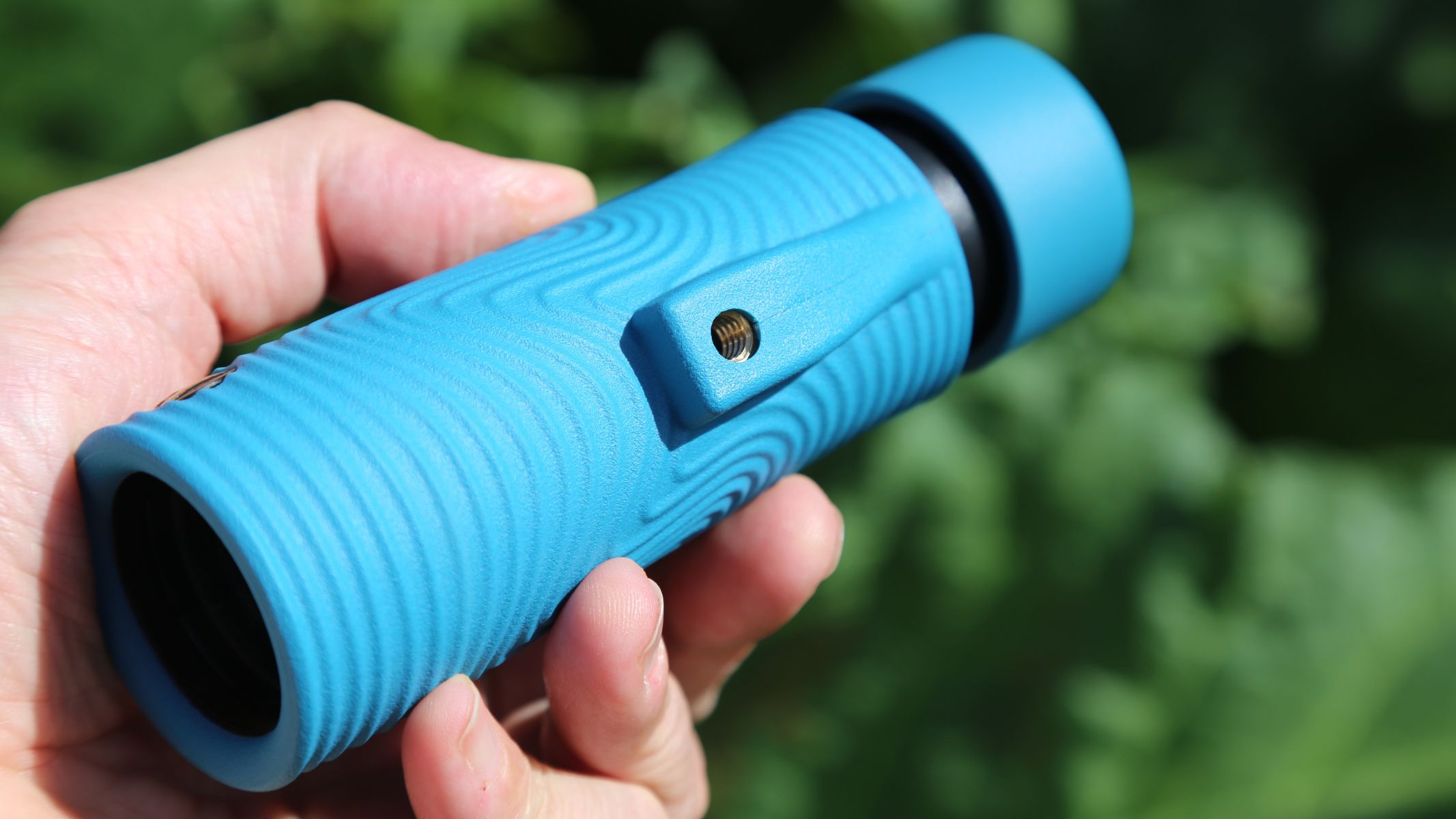 A blue Nocs Provisions 8X32 Field Tube monocular review in the author's hand.