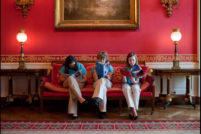 Students, from left, Gaby Dempsey, 12, Kate Murray, 13, and Mackenzie Grewell, 13, read in the Red Room of the White House after setting up their science fair exhibit, Feb. 6, 2012. The three girls, part of the Flying Monkeys First Lego League Team from A