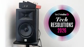 A JBL speaker in a white room next to a tech resolutions logo
