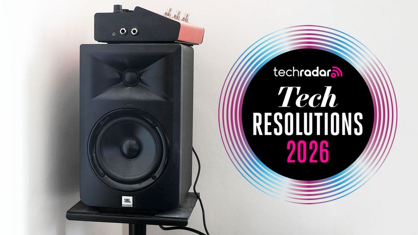 A JBL speaker in a white room next to a tech resolutions logo