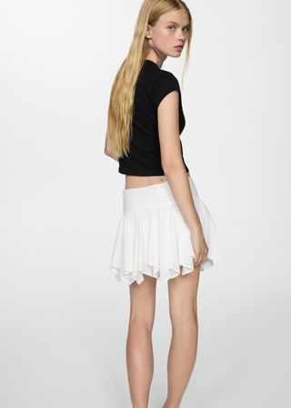 Asymmetrical mini skirt with bow