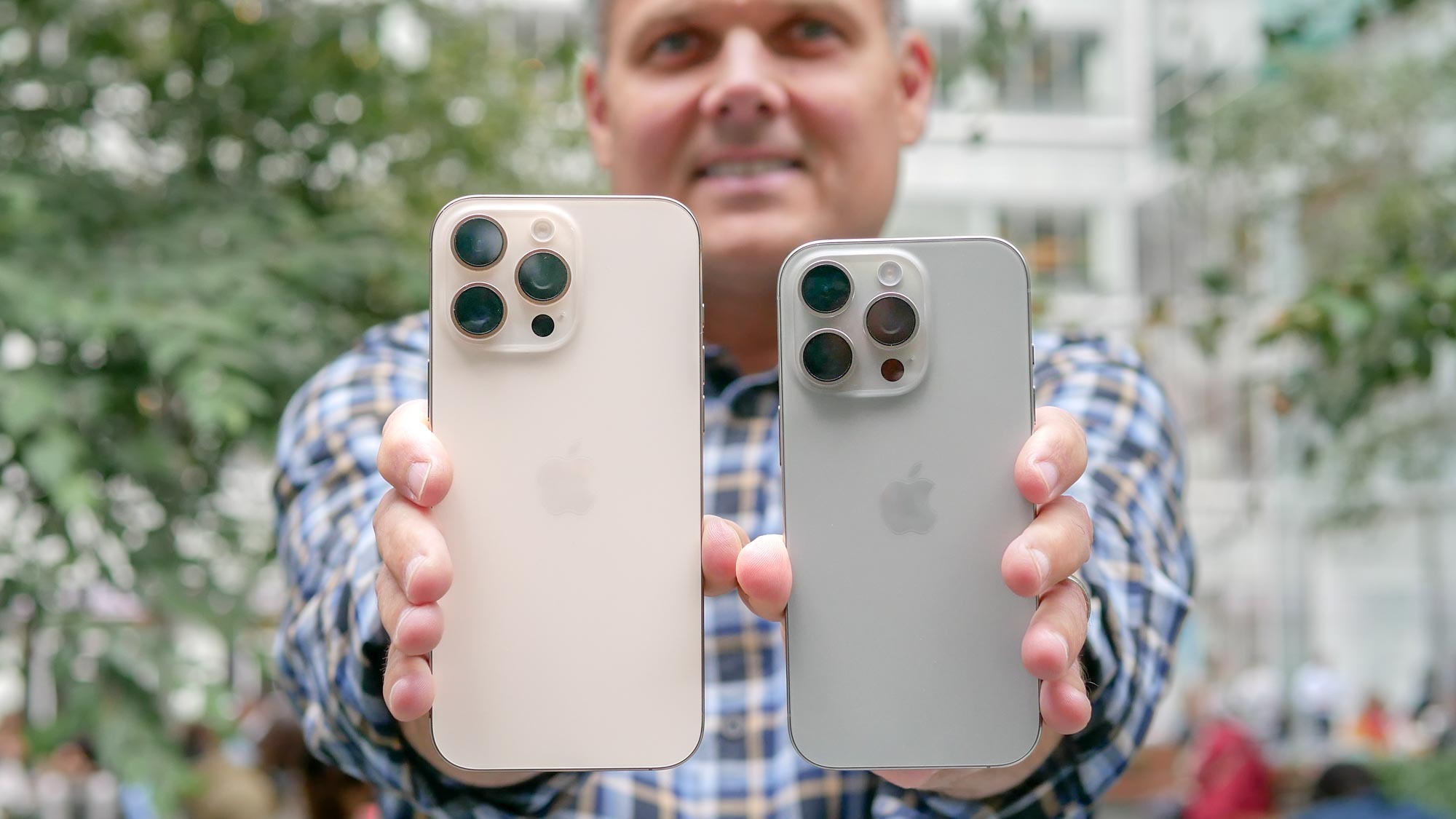 iPhone 16 Pro vs iPhone 16 Pro Max in hand shows the phones back