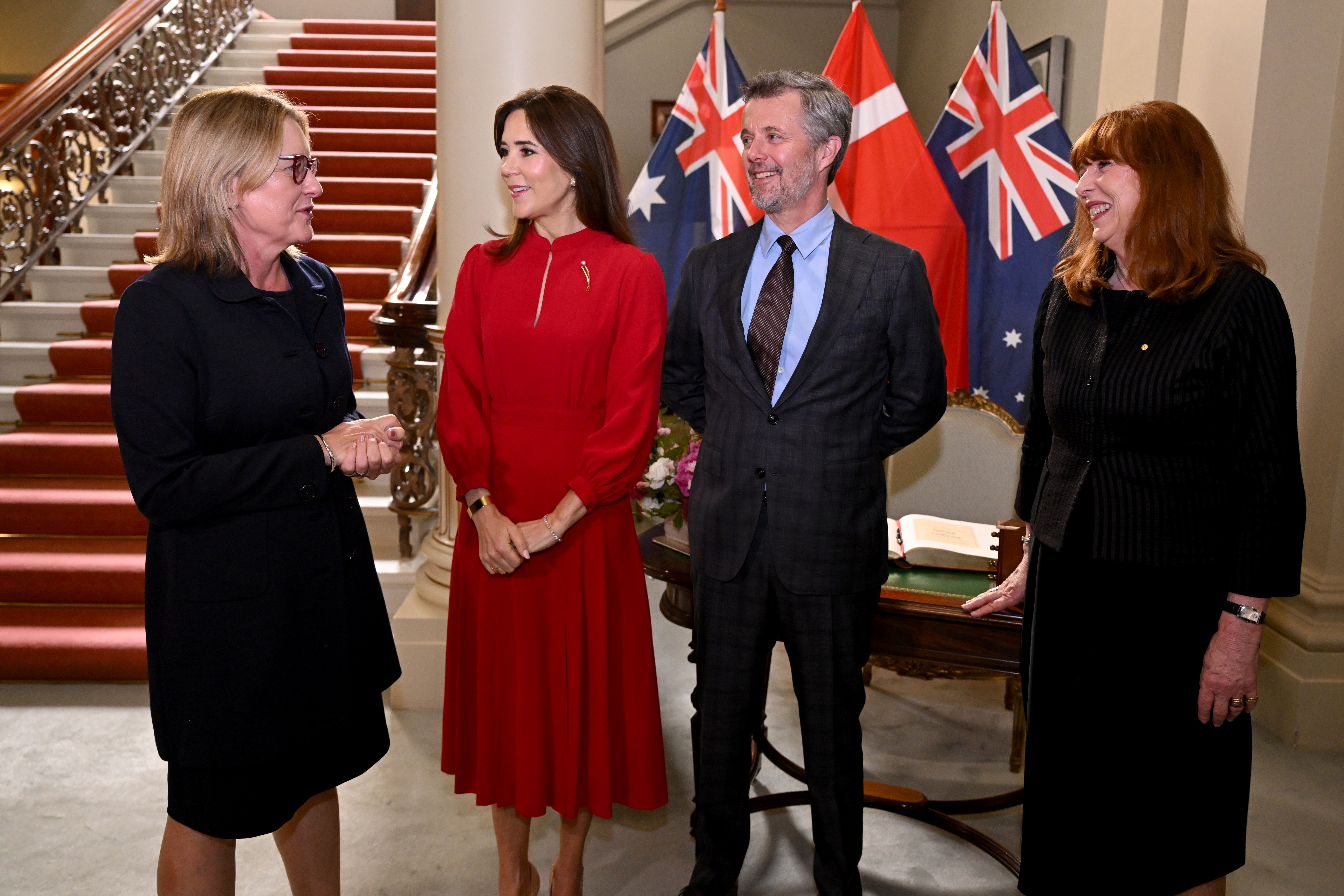 Denmark's King Federik X (2/R) and Queen Mary (2/L) chat with Victoria's state premier Jacinta Allan (L) and Victoria's Governor Margaret Garner (R) after the signing of the guest book at Government House in Melbourne on March 17, 2026.