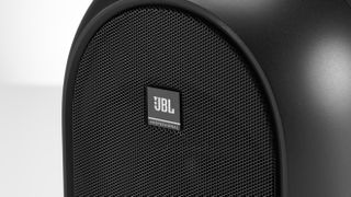 JBL 104 speaker closeup on a white background