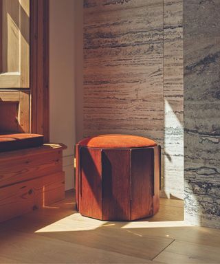 wooden paneled stool with orange velvet seat