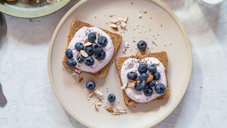 Breakfast plate with wholegrain toast topped with yogurt and berries, an example of how to combat SAD with higher vitamin B12