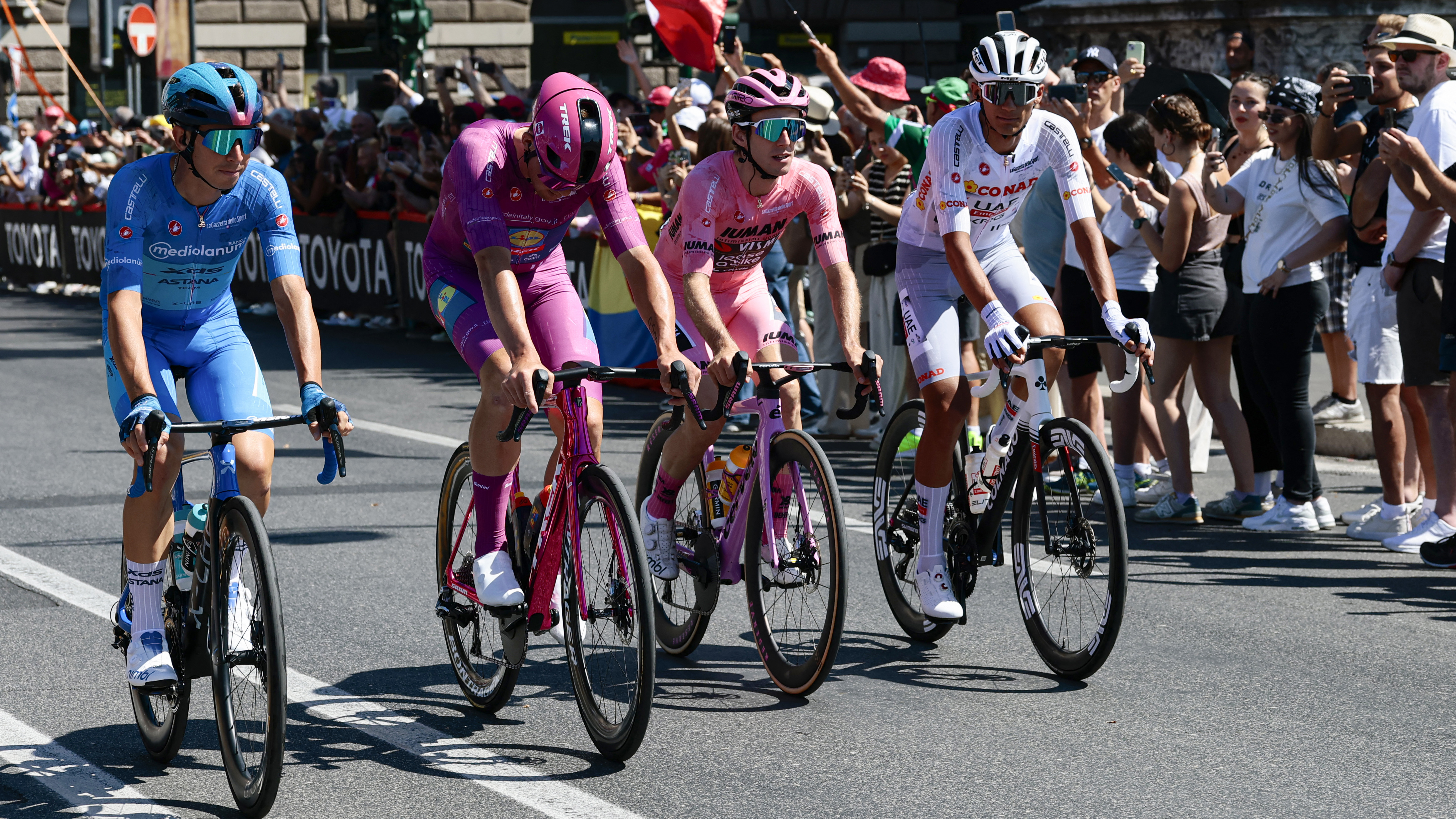 L&ndash;R: Lorenzo Fortunato wearing the Maglia Azzura, Mads Pedersen in the Maglia Ciclamino, Simon Yates in the Maglia Rosa and Isaac Del Toro wearing the Maglia Bianca at the end of the 2025 Giro