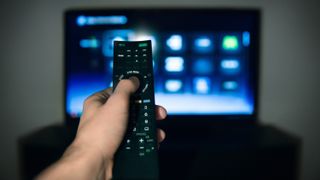 A remote control pointed towards a television