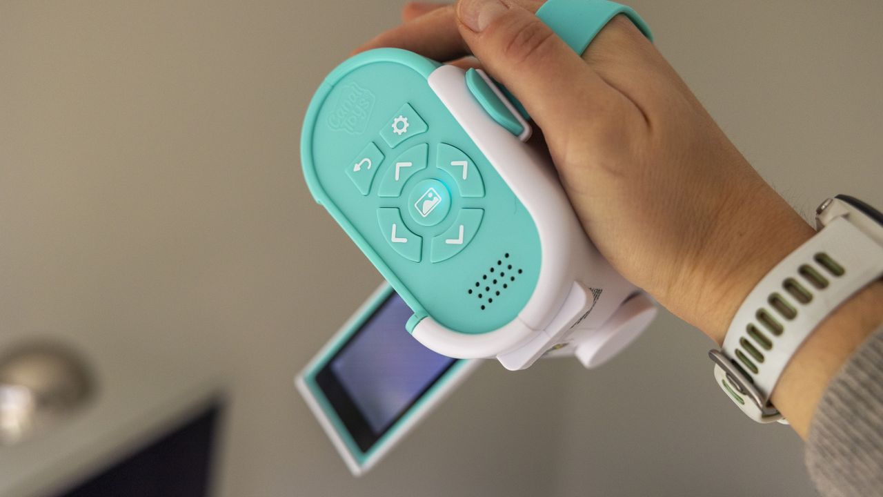 The Photo Creator projector video camera being handled in a home office