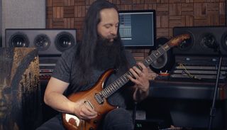 John Petrucci plays his signature six-string Ernie Ball Music Man Majesty guitar