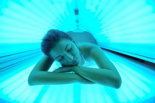 girl inside a tanning bed.