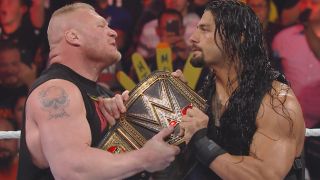 Brock Lesnar and Roman Reigns holding the WWE Championship on Raw