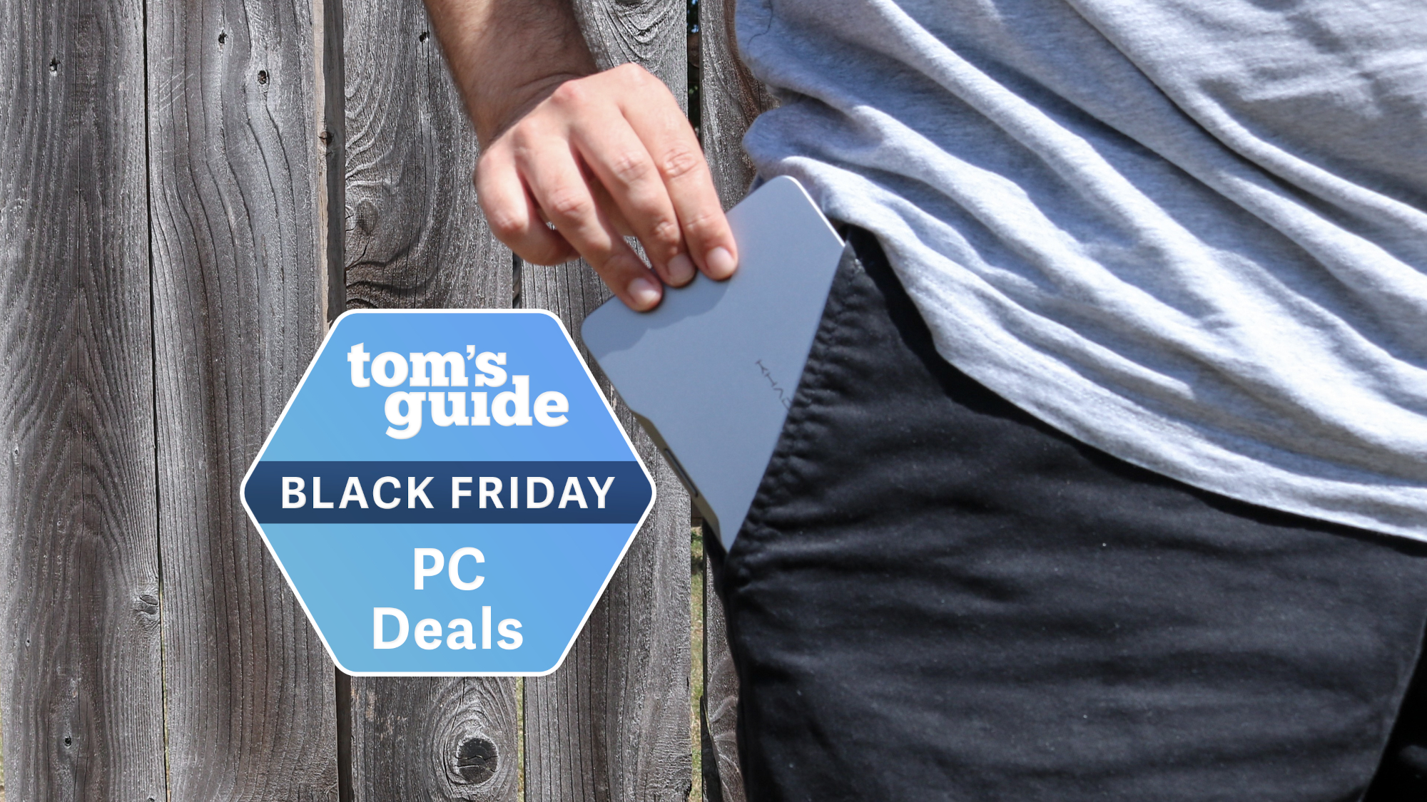 A person slipping the Khadas Mind mini PC into their pocket with a Tom&#039;s Guide Black Friday deals badge