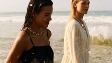 Two models walking through waves on the beach wearing summer clothing from Tesco F&F edit.