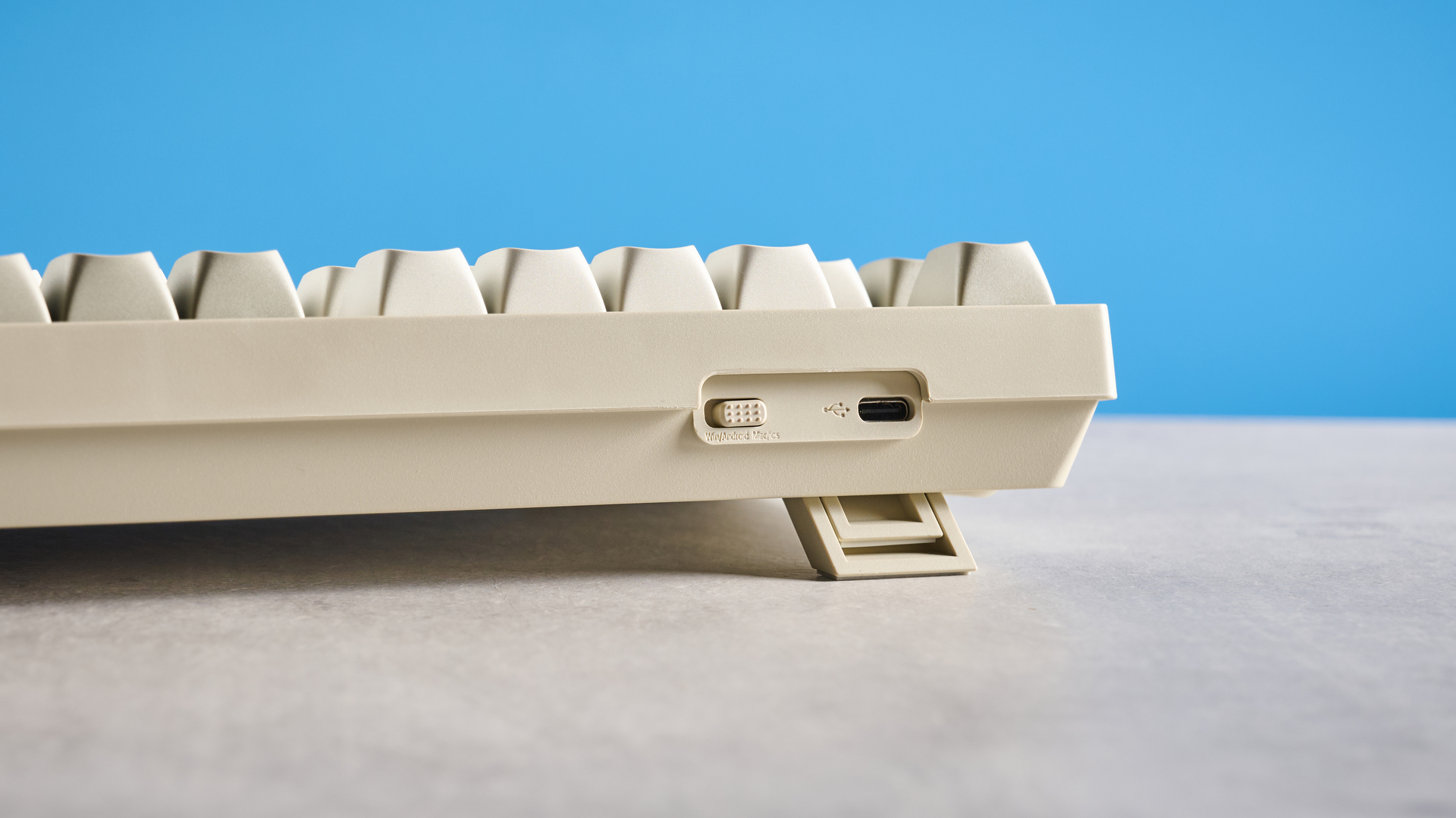 Keychron C1 Pro 8K photographed in front of a blue background.