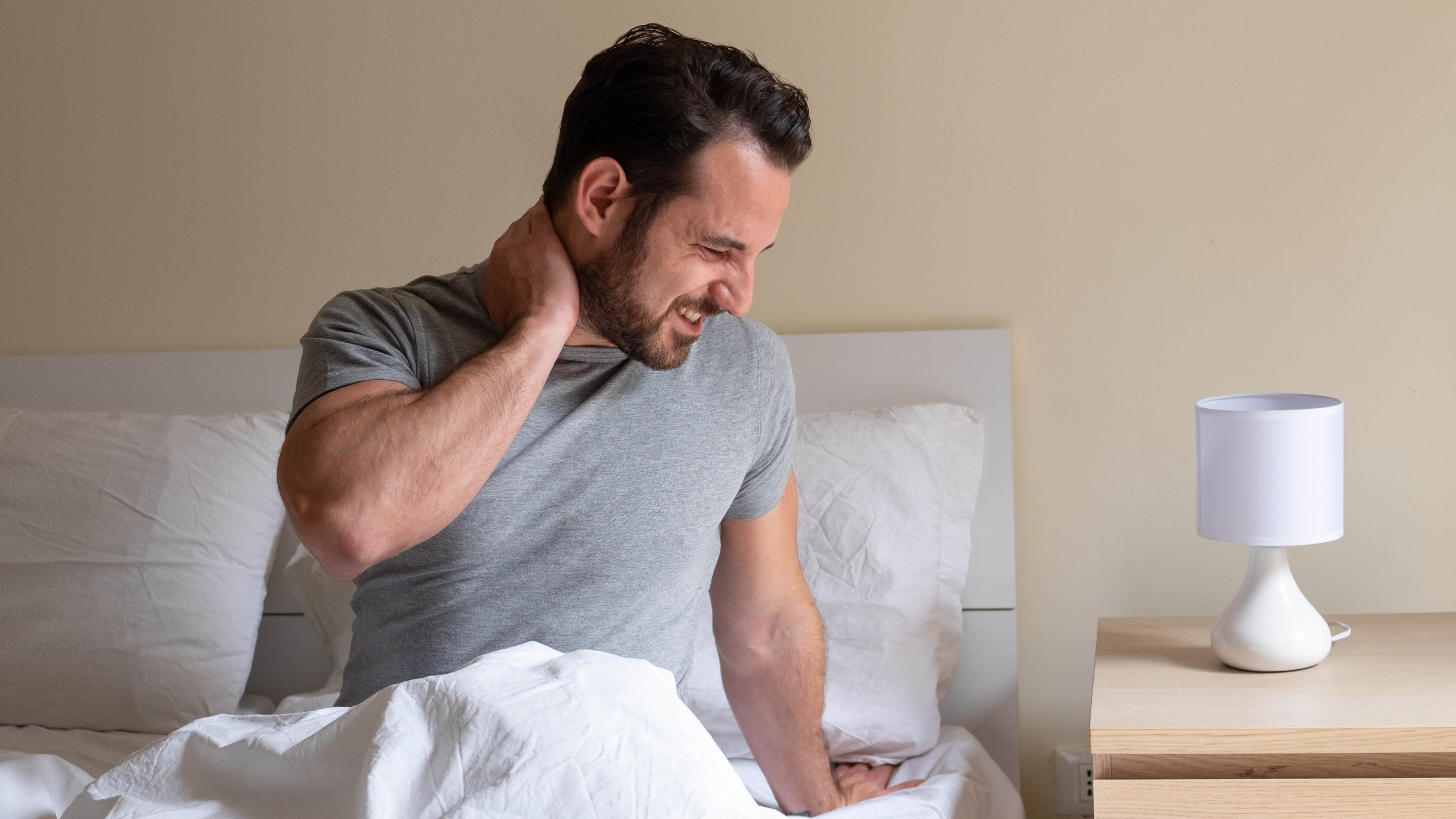 Man waking up with a stiff neck