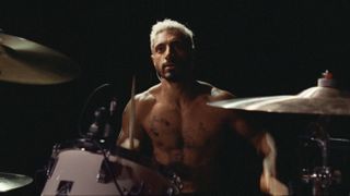 A still from the movie Sound of Metal showing Riz Ahmed's character Ruben playing the drums.
