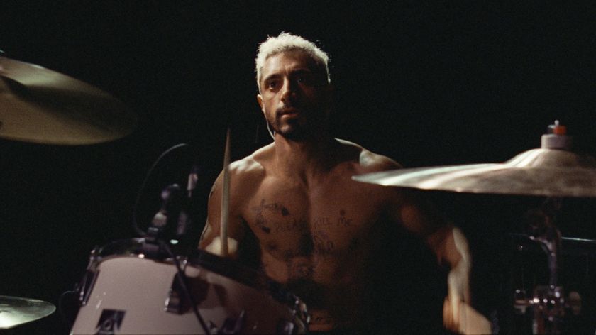 A still from the movie Sound of Metal showing Riz Ahmed&#039;s character Ruben playing the drums.