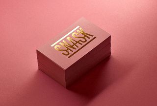 Pink business card featuring just the Snask logo