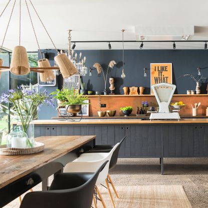 dining area with glass vase and hanging light