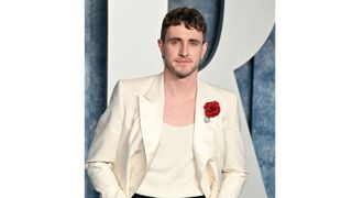 Paul Mescal with a mullet and wearing white suit as he attends the 2023 Vanity Fair Oscar Party Hosted By Radhika Jones at Wallis Annenberg Center for the Performing Arts on March 12, 2023 in Beverly Hills, California.