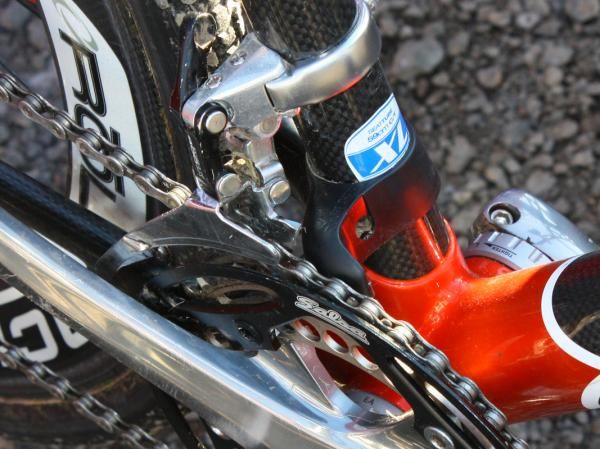 This setup probably works but seems rather excessive in light of more elegant - and lighter - options now available. The chain is kept from jumping to either side by a Salsa outer guard and a Third Eye chain watcher, and is secured up top by a dummy front derailleur.