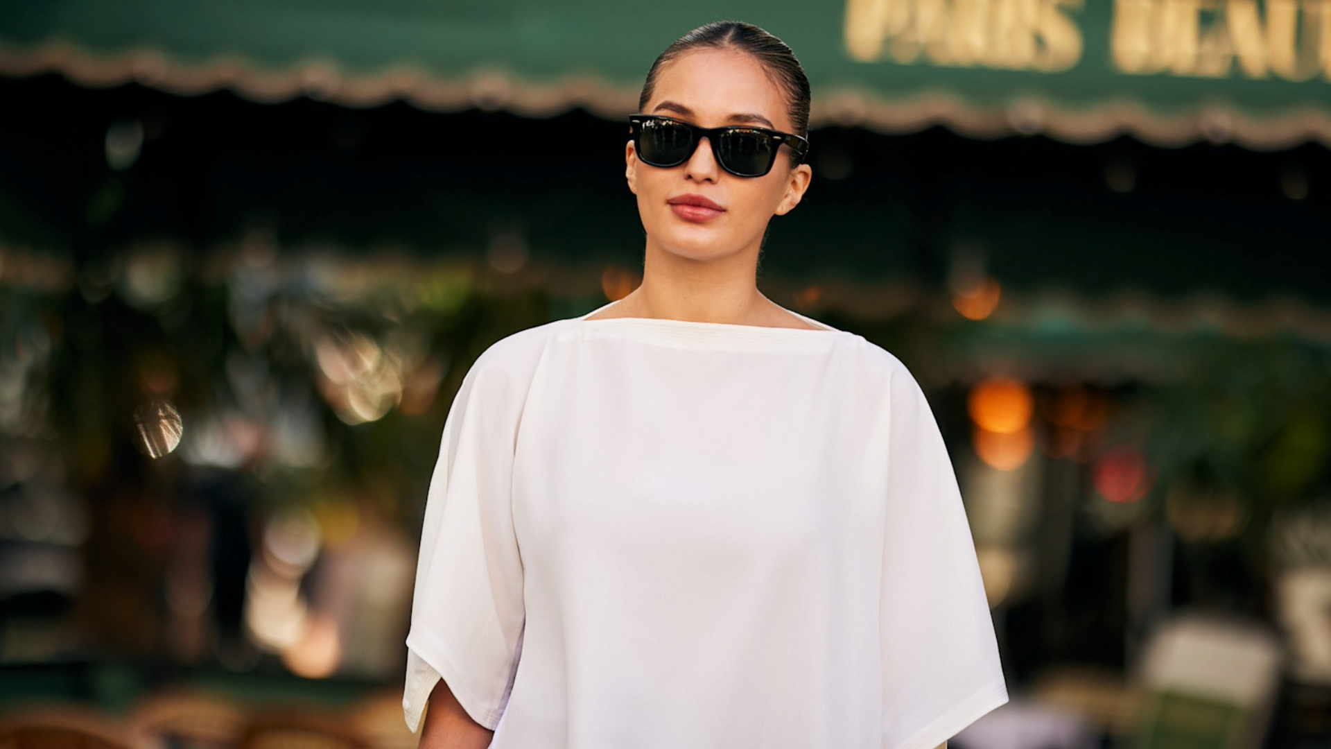 woman wearing black glasses and a white T-shirt. 