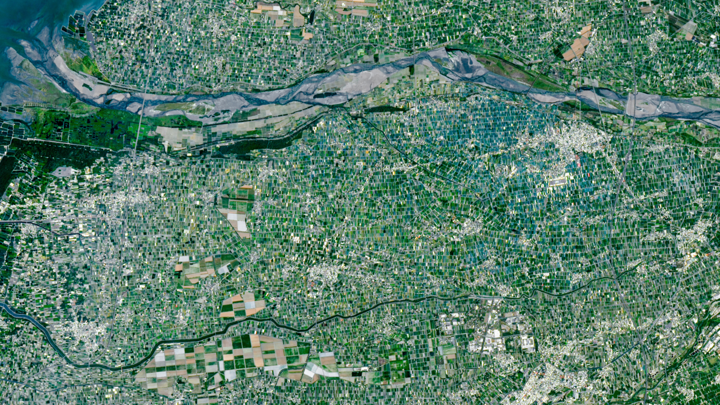 A satellite photo showing tens of thousands of small fields tightly crammed around a river in Taiwan
