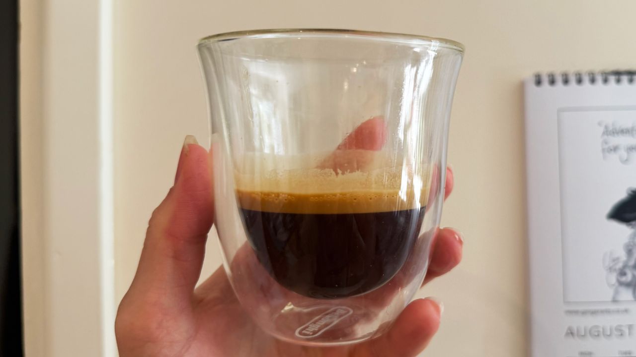 a photograph of an espresso shot pulled on the breville bambino plus in a small glass