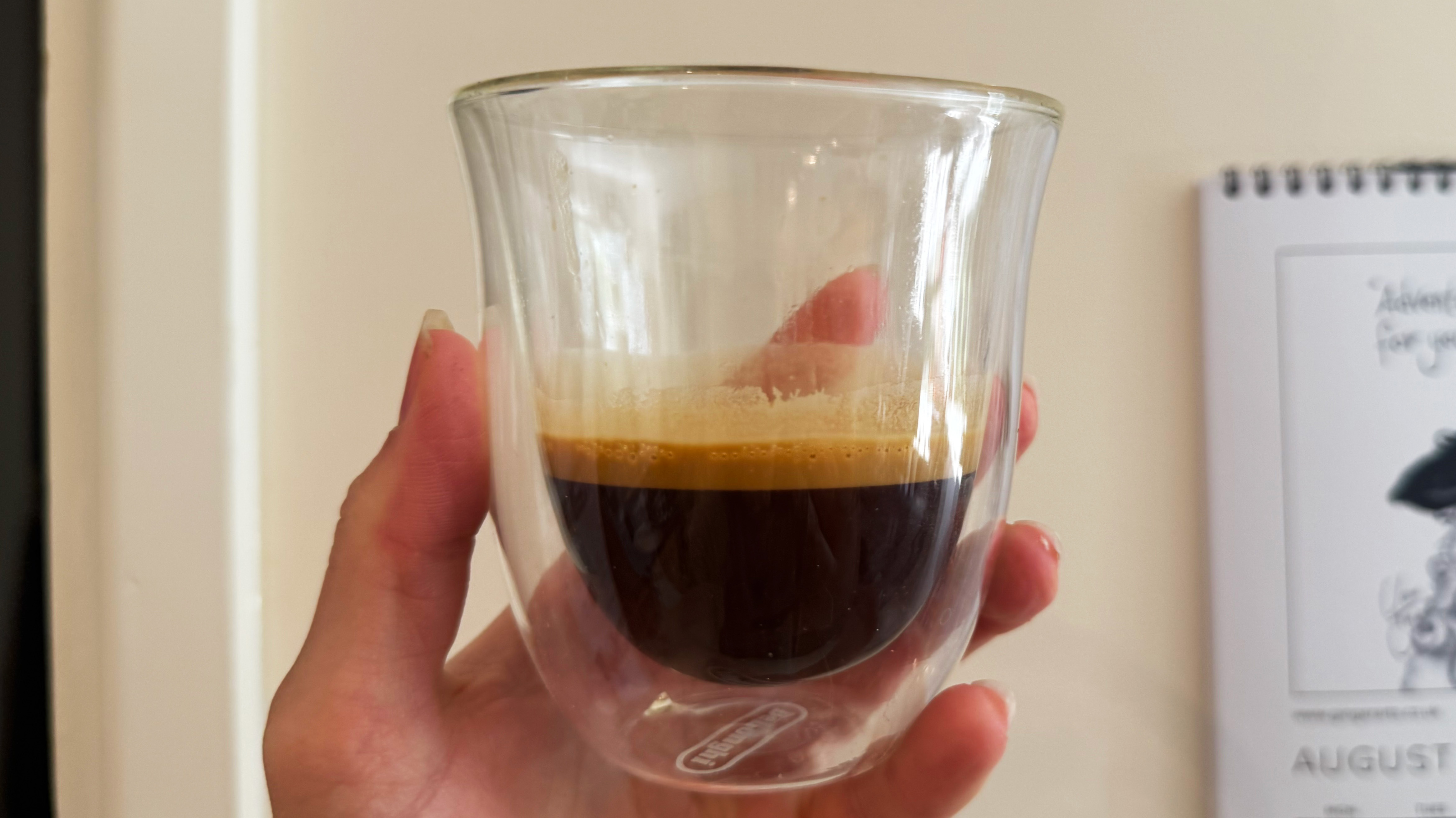 a photograph of an espresso shot pulled on the breville bambino plus in a small glass
