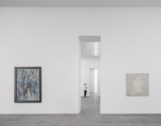 View through slit doors between white galleries at Museum Küppersmühle Duisburg