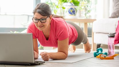 senior woman does plank hold at home