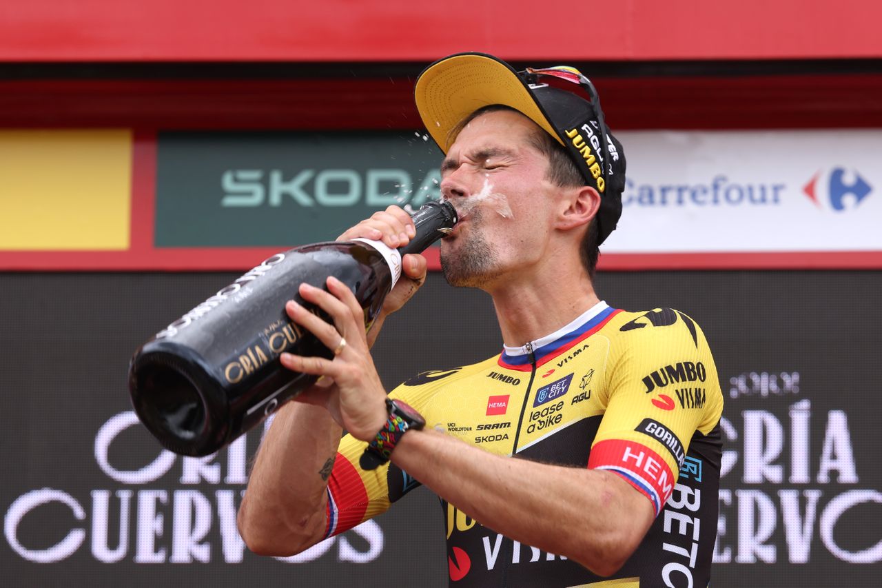 Primoz Roglic downing a magnum of champagne