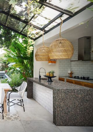 An outdoor kitchen with a granite countertop