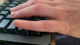  A hand with fingers on the keys W, A, S, and D, with the lower part of the pinky pressing down on Ctrl.