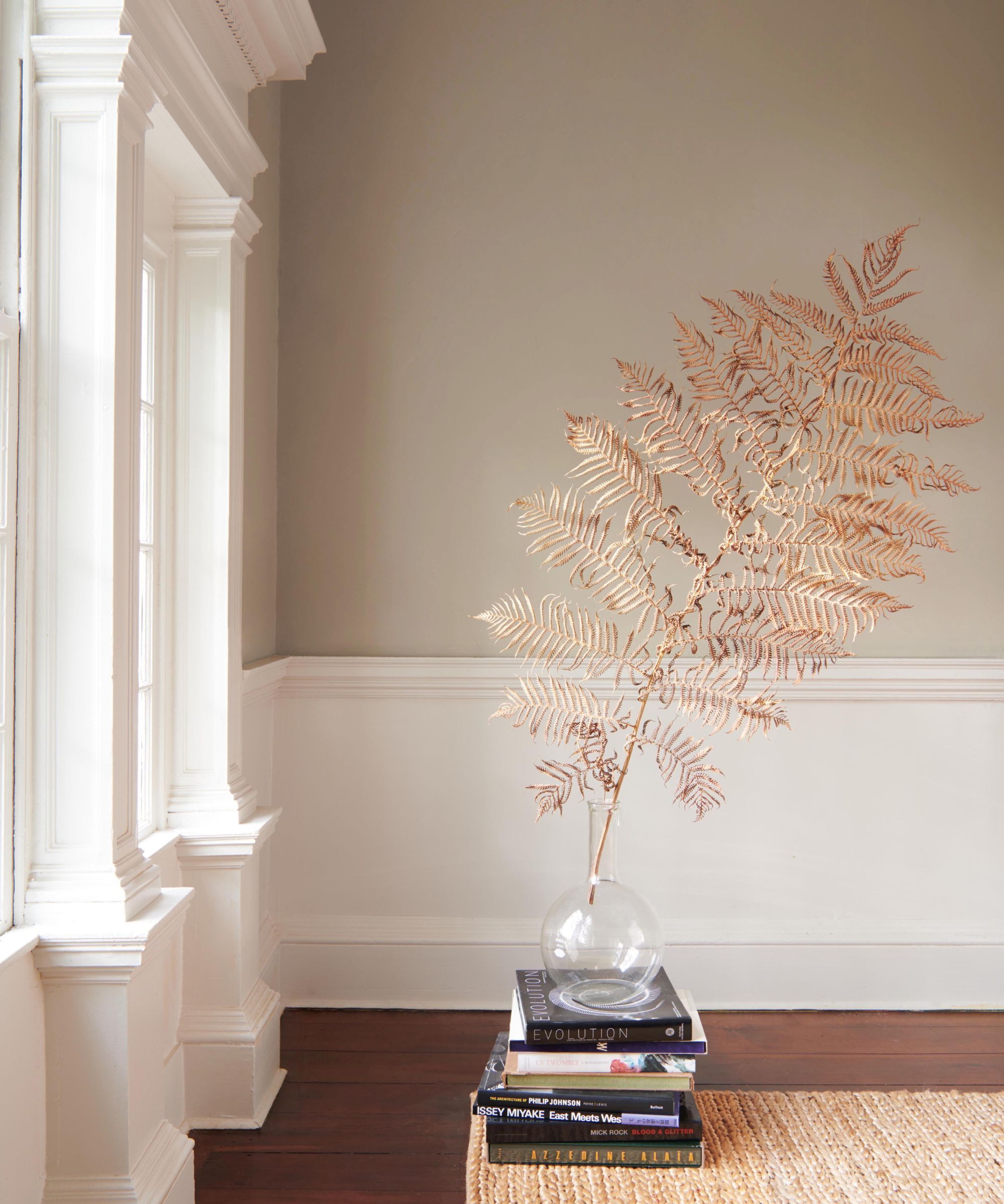 A wall painted in beige with a white border