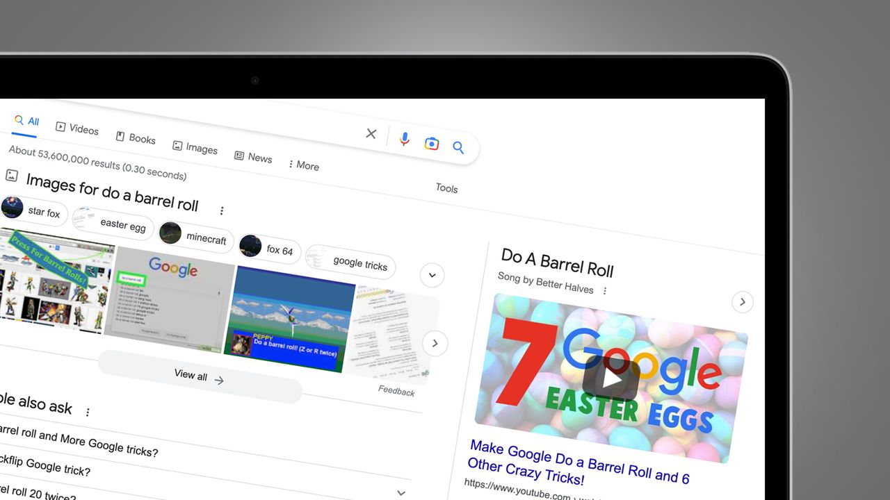 A laptop screen on a grey background showing the Google barrel roll easter egg