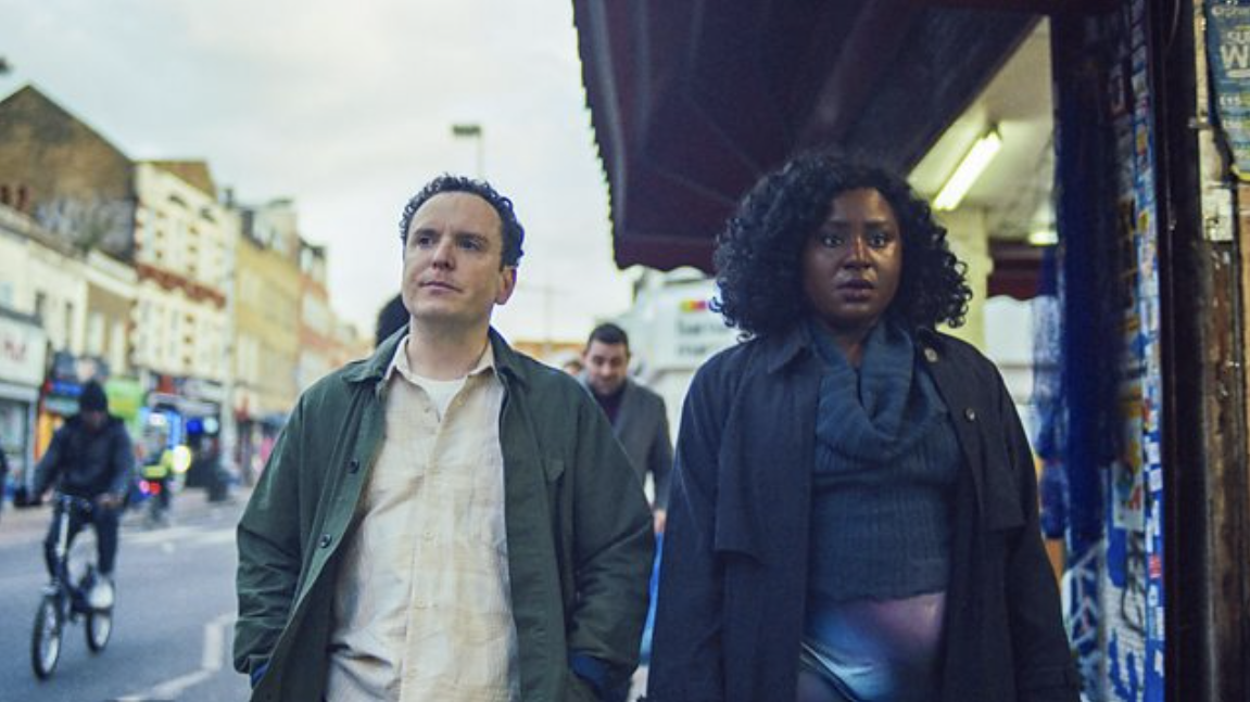 Josh (Joshua McGuire) and Fola (Susan Wokoma) walking down the street in Cheaters Season 2